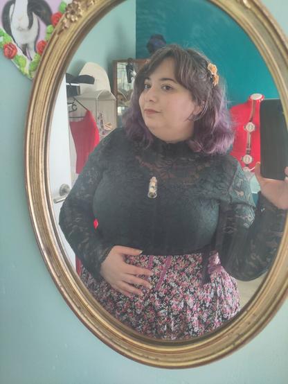 Close up outfit picture in a golden oval mirror