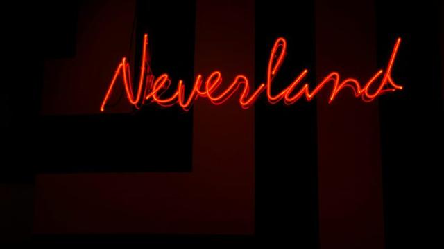 red neon sign reading ‘Neverland’