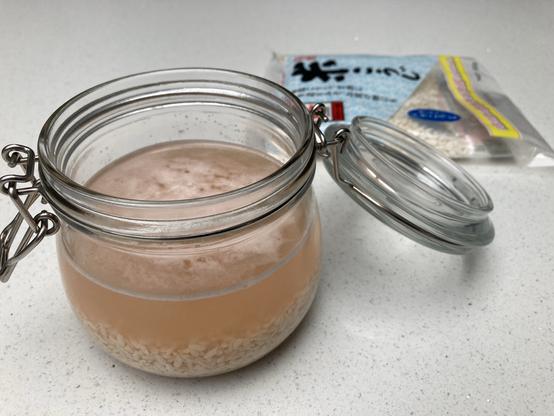 Shio Koji in a kilner jar with Koji rice in the background.