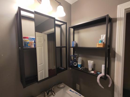 The corner of our bathroom above the sink with a pair of Ikea Enhet frames to hold medicine cabinet items. The one in front of the sink has a sliding mirror attached to the front which I think gives a neat modern look. I hope the open frame design will help keep me more organized because I can see all of my stuff when I'm looking for it and don't have to open a cabinet.