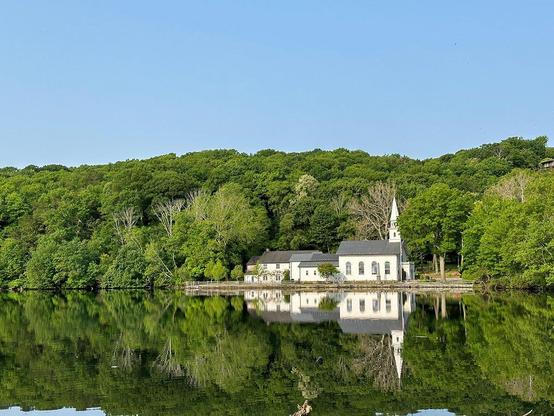 Gorgeous view of St. John's Church of Cold Spring Harbor, reflected in the pond right next to it.