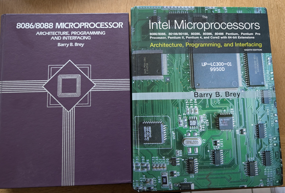 On the left is one of the early 8086/8088 Microprocessors book, and on the right the last? edition for 8088 - Core2 CPUs. They are written by Barry Brey and sitting on a desk, put there with love.