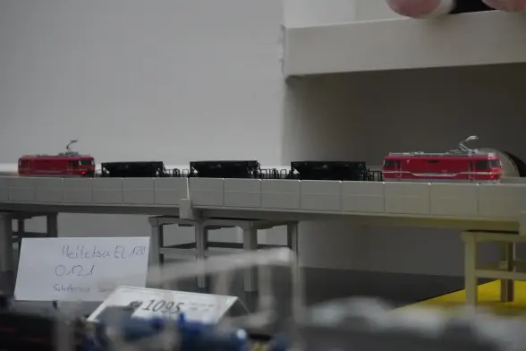 An elevated section of the model rail with a cargo trai  and 2 wagons for split stone.