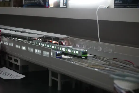 An elevated station with 3 parked trains currently waiting.