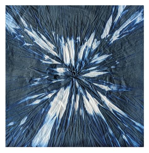 A piece of white paper which shows creases from being folded into an origami form - in this case a random crushed form focused on the centre - and exposed as a cyanotype. This means it has blue all over it with random white areas.  Looks a bit like a white ice shard explosion on a blue background