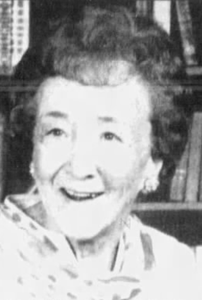 Elen Longone, nee Eleanor La Mance, from a 1985 obituary; a smiling older white woman with hair in a set style, in front of a bookcase