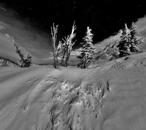 The mountains winds left its mark on the snow covered slopes of the frozen mountain.