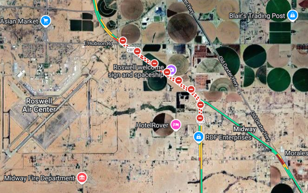 Road closed near Roswell welcome sign and spaceship