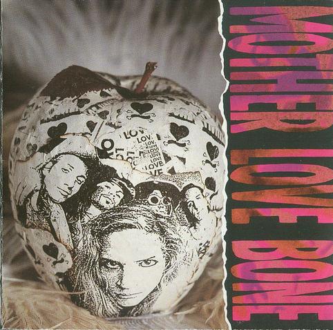 The cover art is a photo of what looks to be an apple that is wrapped in paper, with a black and white photo of the band printed on it as well as randomly placed hearts and the word "LOVE". The band name is in a a bunch of pink/red shades, written sideways along the right edge against a black background. It looks like a photo of something is captured inside the letters, but it's hard to make out what it is.