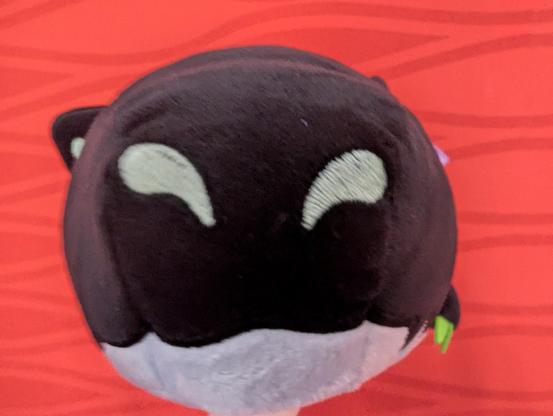 A photo of the snout of the longboi plush (an about 50cm long black and green dragon). It's really near to the camera, like it's about to say: "You've got games on your phone?".