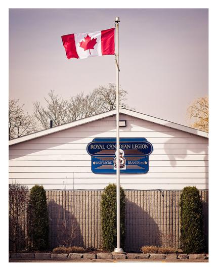 Outside a Royal Canadian Legion building with the Maple Leaf flying.