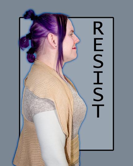 The image features a woman with purple hair styled in a bun at the back of her head, facing left. She wears a tan cardigan over a white shirt with lace sleeves.
In the background, a gray rectangle contains the word "RESIST" in black text, rotated 90 degrees counterclockwise and aligned vertically. The image is set against a solid gray background.