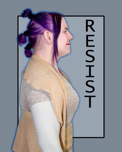 The image features a woman with purple hair styled in a bun at the back of her head, facing left. She wears a tan cardigan over a white shirt with lace sleeves.
In the background, a gray rectangle contains the word "RESIST" in black text, rotated 90 degrees counterclockwise and aligned vertically. The image is set against a solid gray background.