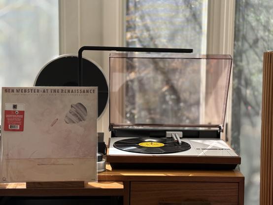 Ben Webster - At the Renaissance LP.

A cut-out of Ben’s head and the mouthpiece of his sax on a beige-and-white wall.

The black LP plays on a vintage, restored Bang & Olufsen Beogram 4000 linear-tracking turntable to the right.