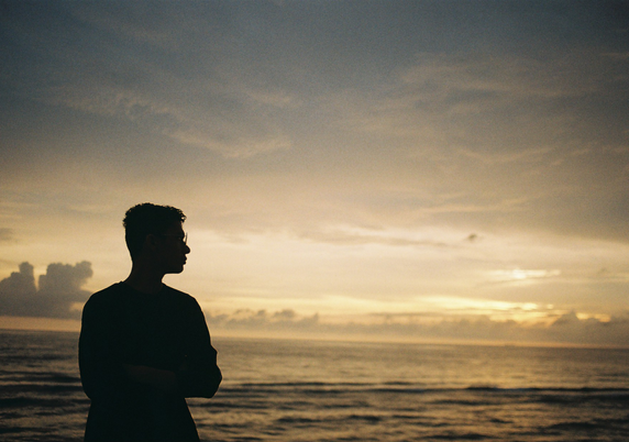 Silhouette of Adrian by the sea.