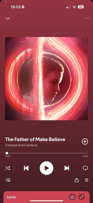screenshot of song playing in Spotify. Background is red. Album cover shows a boys face inside the event horizon of a black hole.  The name of the song playing is "the father of make believe" by Coheed &amp; Cambria.