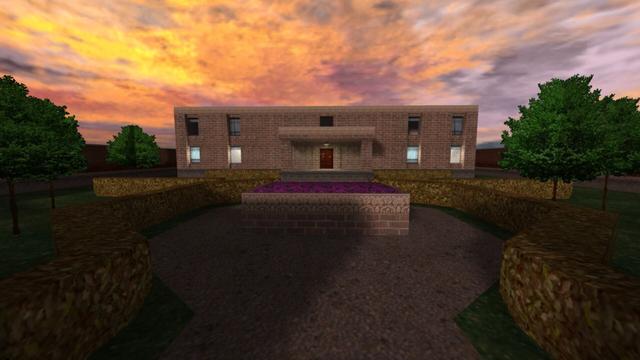 In this picture you can see an estate, which is also the name of the Map. This is two-storey. On the way to the entrance of the estate is a raised flower bed, with purple flowers inside, in the middle, so you have to go past it to the left or revht. In order not to step on the lawn, where there are trees, a small hedge prevents you to the left and right of the path. The estate has a flat roof and a raised entrance with a roof and a dune brown wooden door. Above this, a white-lit lamp hangs from the ceiling. You can see a total of nine windows. Four to the left, four to the right of the entrance and one above it. Left and right are the more congruent. So two on top and two above. At the lower windows, light burns in the rooms below. The Estate is a very slightly reddish brick building. Furthermore, it is afternoon. This is on the map cs_estate in the game Counter-Strike 1.6.