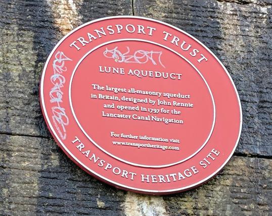 The heritage sign for Lune Aqueduct designed by John Rennie and opened in 1797 for the Lancaster Canal Navigation