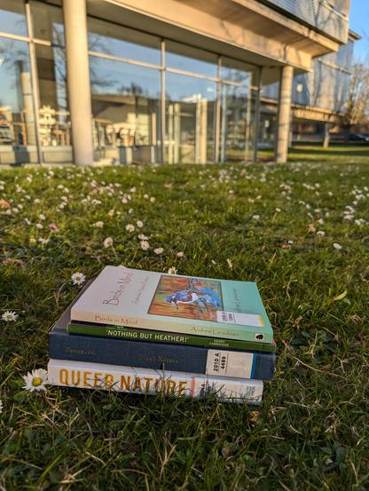 A stack of 4 collections and anthologies of nature poetry on the meadow in front of SUB Göttingen