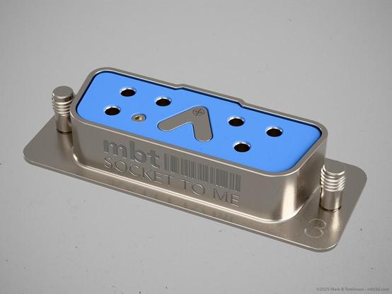 Small RS-232 type socket with only 6 pin sockets and inverted V pin in the centre.
"Socket to me" inscribed on the front.