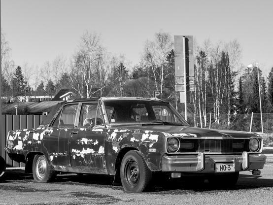 Old Dodge automobile with peeling paint, monochrome, high contrast.