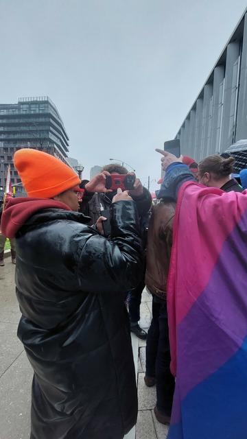 Caryma ignoring the literal new Nazis behind her, while Lee peeks around to take picture of me