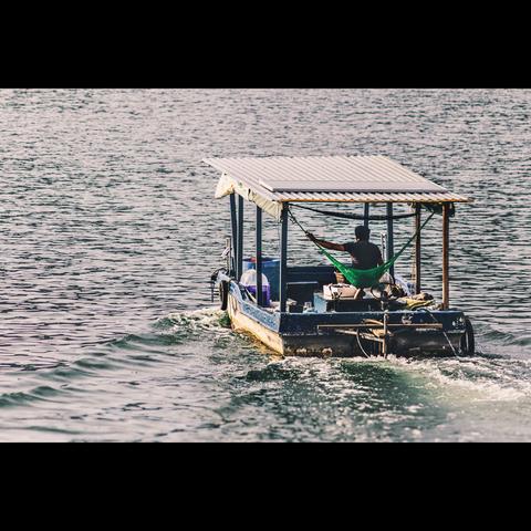 Photo in color of a fisherman boat in Halong bay, Vietnam