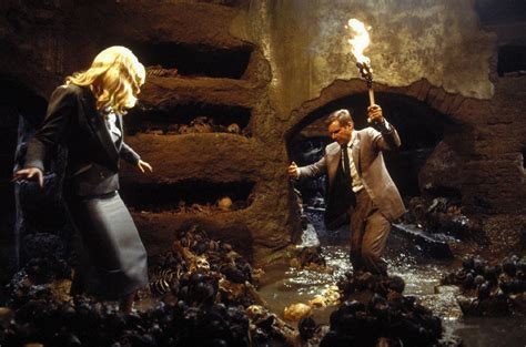 Indiana Jones and a blonde woman, who I think turns out to be a double-agent, in a crypt.