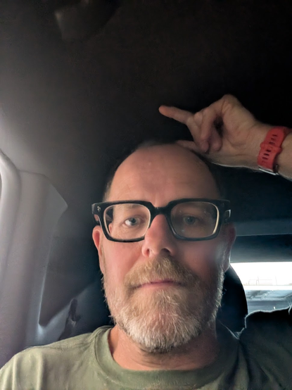 Demonstrating the around 3-4cm space above my head in the back seat