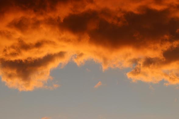 Dark orange cloud at top, light orange skies at the bottom