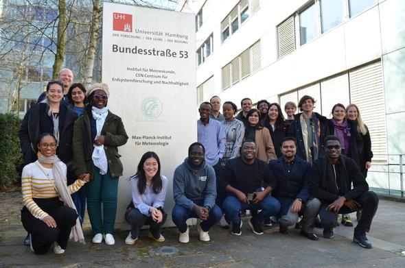 A group of young researchers in front of the Max-Planck Institute for Meteorology in Bundesstrasse 53 in Hamburg, Germany.