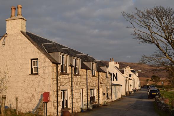 Village of white houses with red postbox