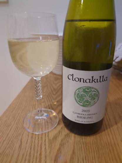 A cut-crystal glass with a bottle of 2023 Clonakilla Riesling next to it.
