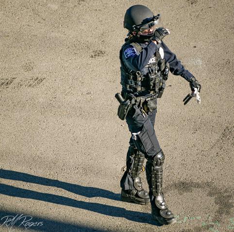 Photograph of a Seattle policewoman wearing tactical gear.