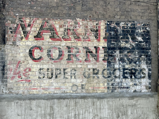 Old supermarket sign on brick wall