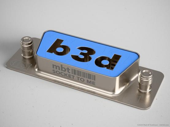 Small RS-232 type socket with b3d inset into it.
"Socket to me" inscribed on the front.