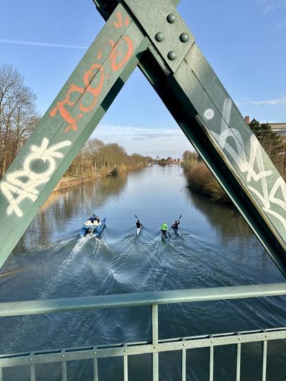 Paddlers on a canal, sen from a steel bridge.