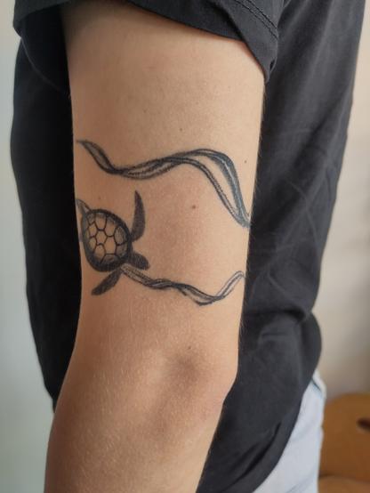 healed brushstroke with turtle swimming around the arm