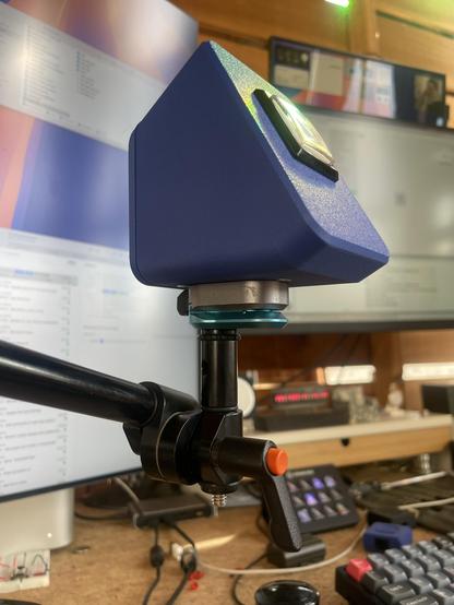 A heroic shot from a low angle of the button mounted to an adjustable arm.