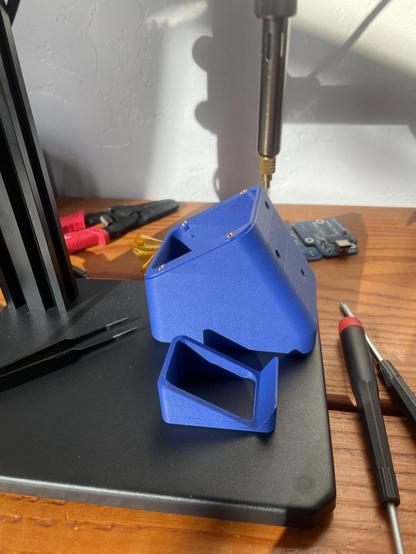 A photo of the bush press and jig which holds the button at a 30° angle so the back face is flat