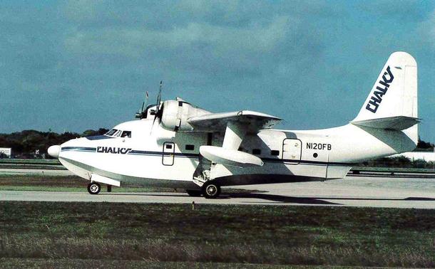 Seaplane on its wheels is taxing by right to left.