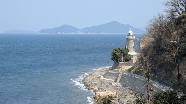 A small road on the side of the island leading to a lighthouse.