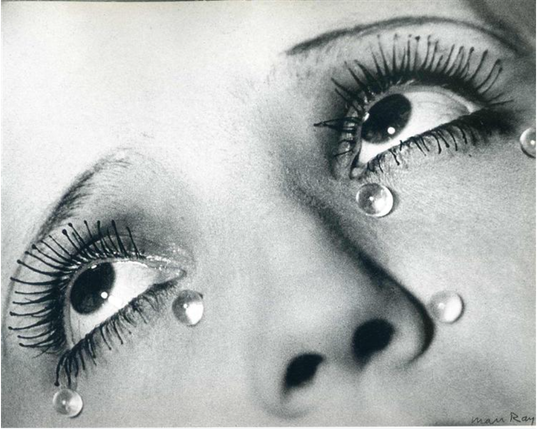 woman's dark eyes looking up with glass tears towards the bottom of her eyes.