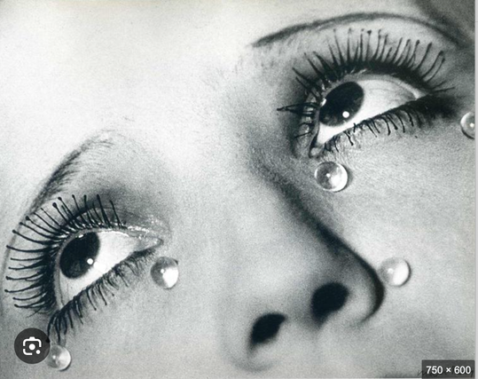 Woman's eyes upturned. round, small glass tears towards the bottom of her eyes.