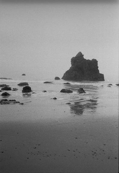 Rocky sand, wet reflective sand, sea rocks, and endless gray with n horizon as I gaze into the Pacific.  Actually, Pt Reyes is out there somewhere in this direction.