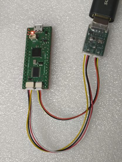 On the left is my Pico 2 clone PCB. It has no buttons, the red LED is illuminated. On the bottom edge are 4-pin (I2C) and 3-pin (UART) connectors, both of these have wires to one of my RP2040 Interfacer PCBs which is on the right.