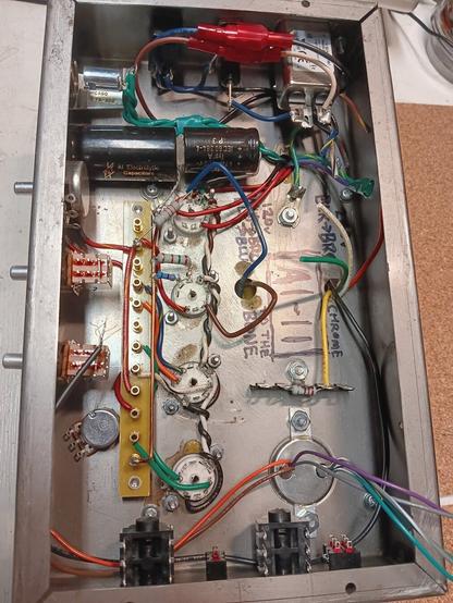 Inside view of Audity One Recording Amplifier head with wires and electronic components. Words are written in black marker, including, "Chrome to the Bone"