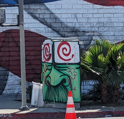 Utility box painted like a cartoon man with a thick mustache