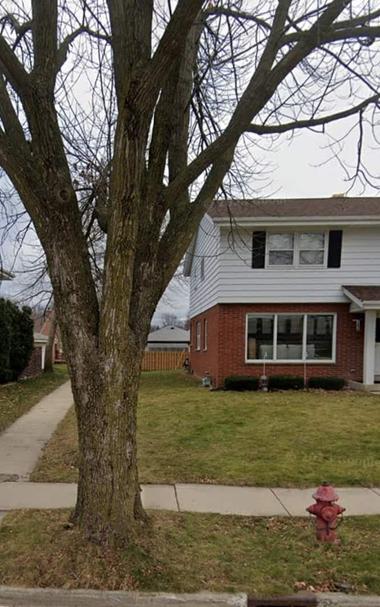 Street view from 2022 showing the curb and now a much taller, bigger tree.