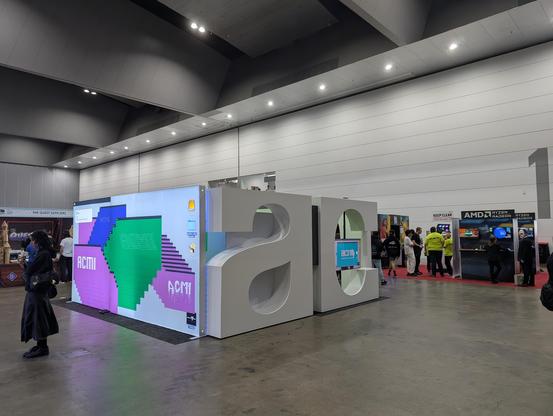 ACMI stand with large AC and ASCII art